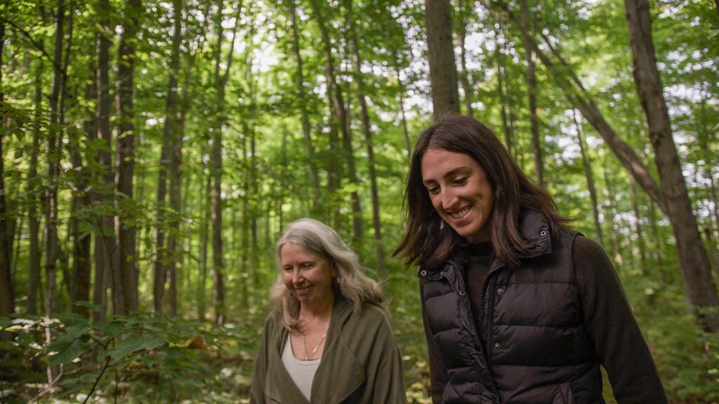 two women walking in the woods