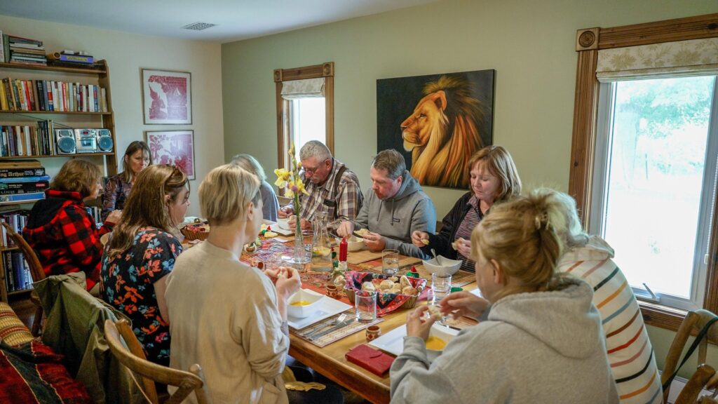 Group of people eating a meal at a harvest table