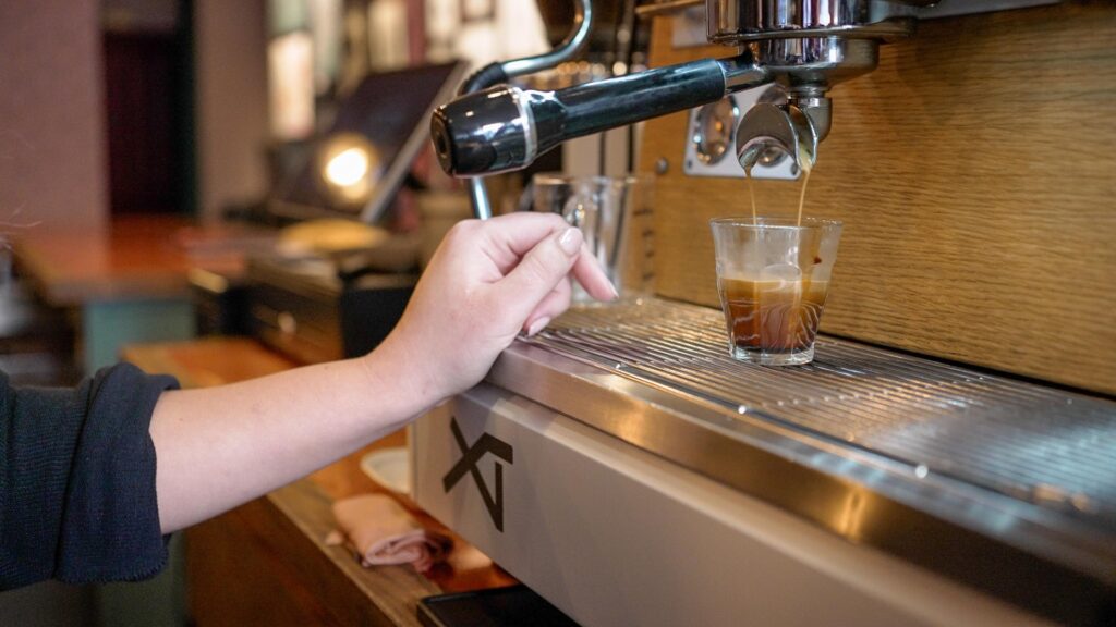Person preparing an espresso