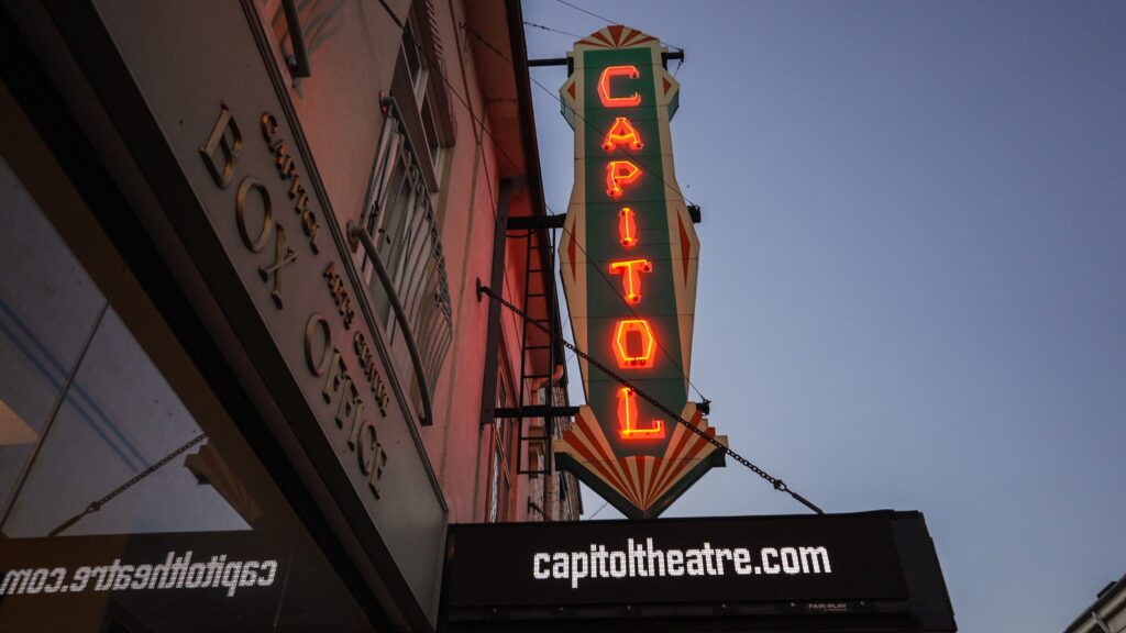 Exterior marquee for Capitol Theatre in Port Hope, lit up at night.