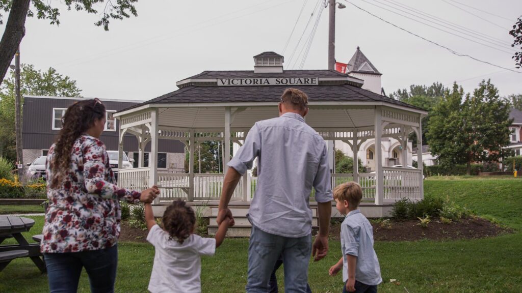 Family walking toward the Victoria Park gazebo in Colborne
