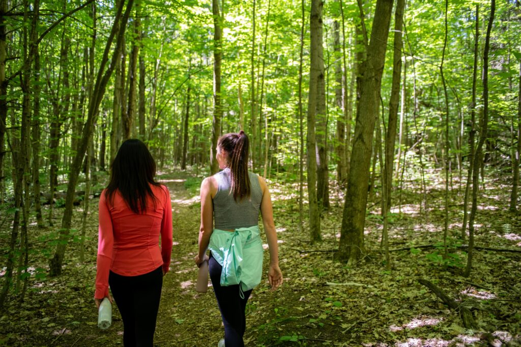 Two women walking on a trail in spring