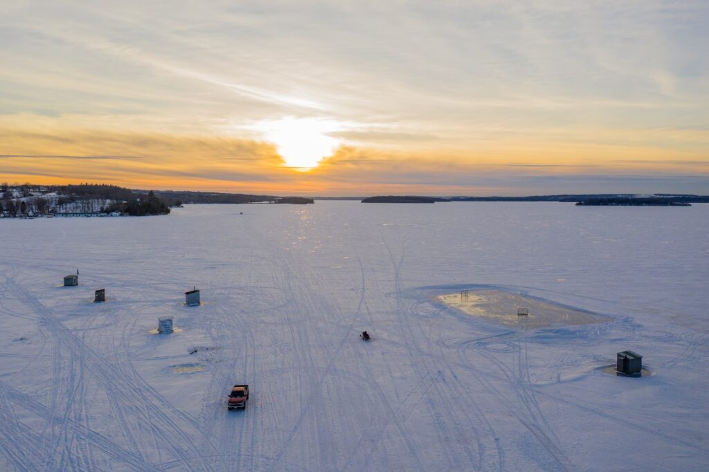 Drone view of fishing huts on a frozen lake