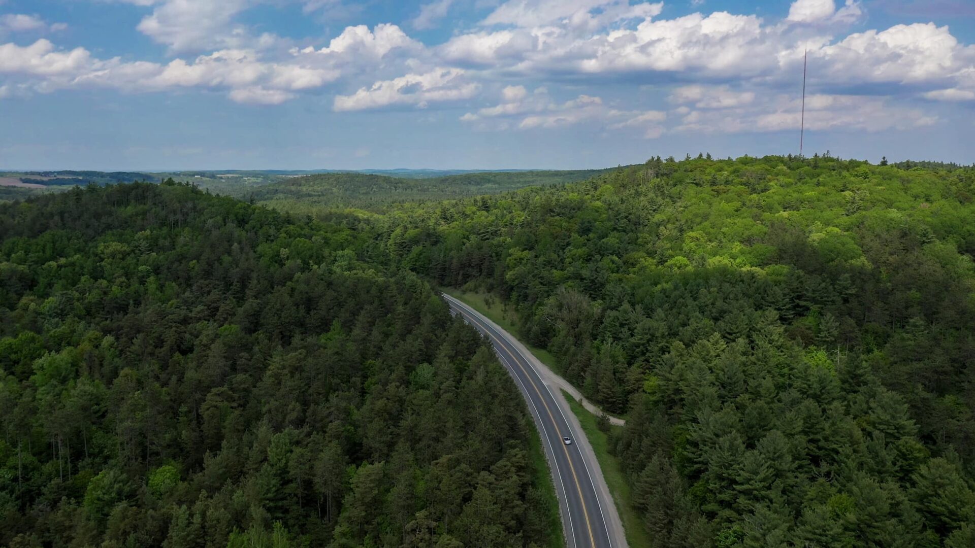 Drone view of highway through forested areas