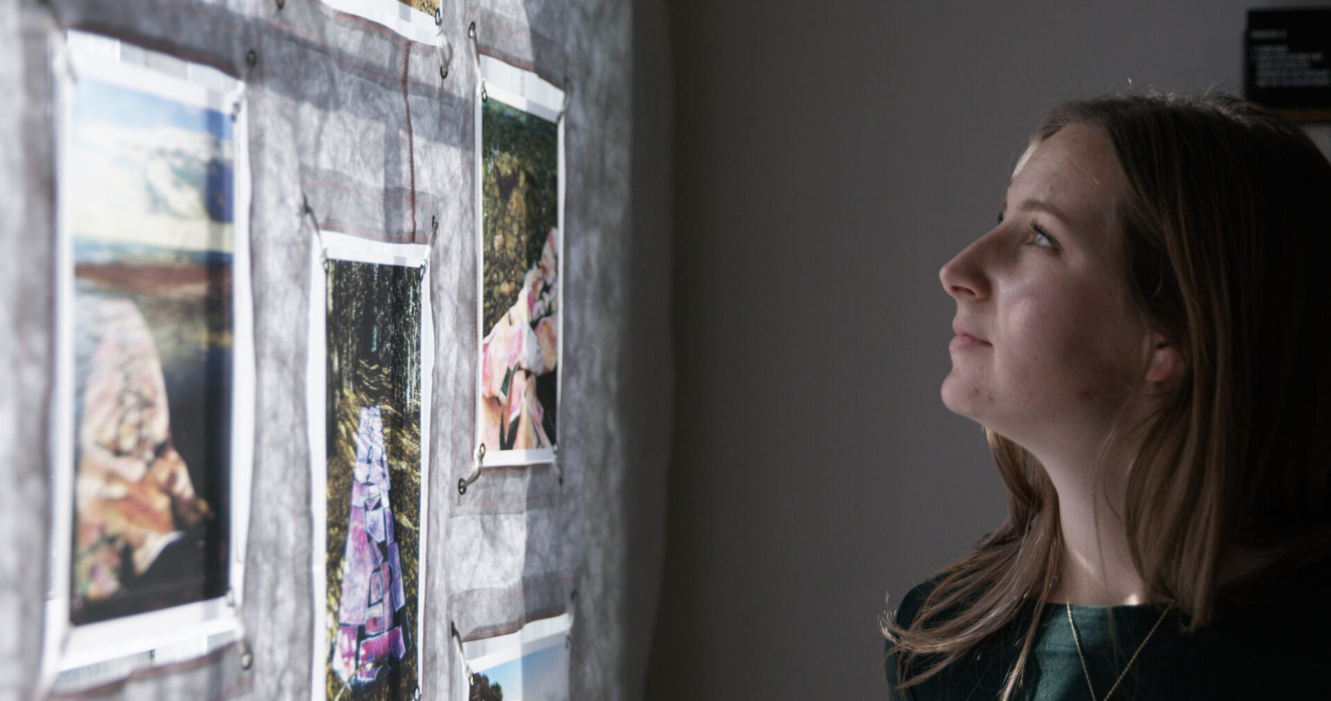 Woman looking at collection of prints at the Art Gallery of Northumberland.
