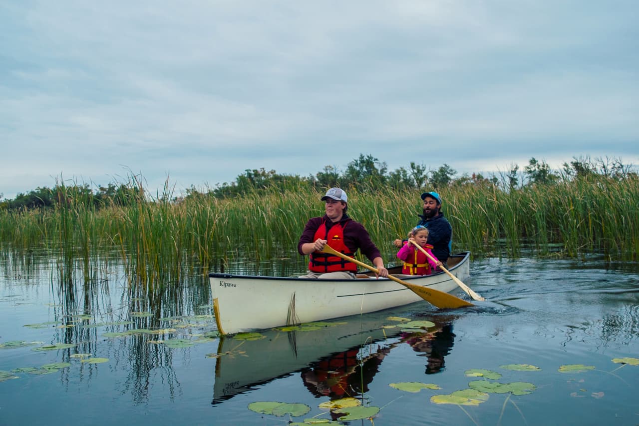 Couple in a white canoe in fall
