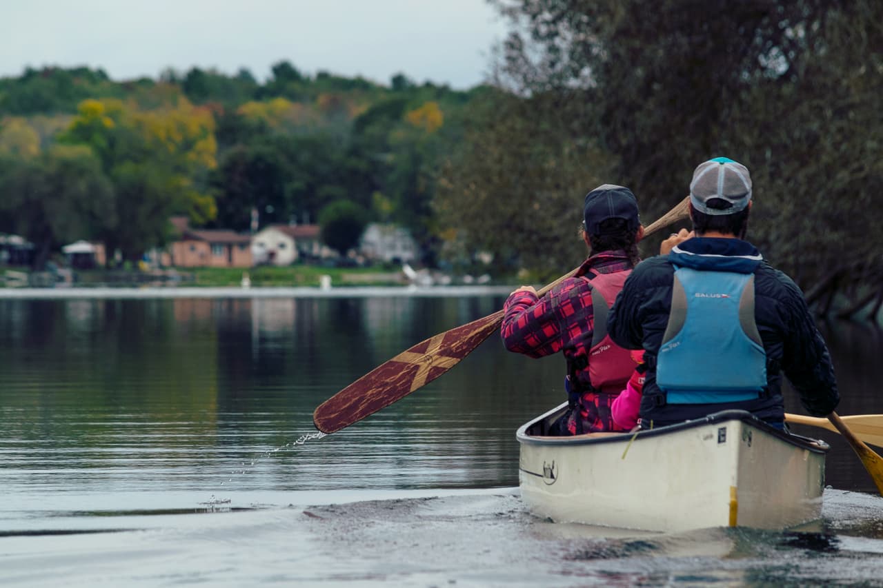 Man and woman canoeing in a white canoe