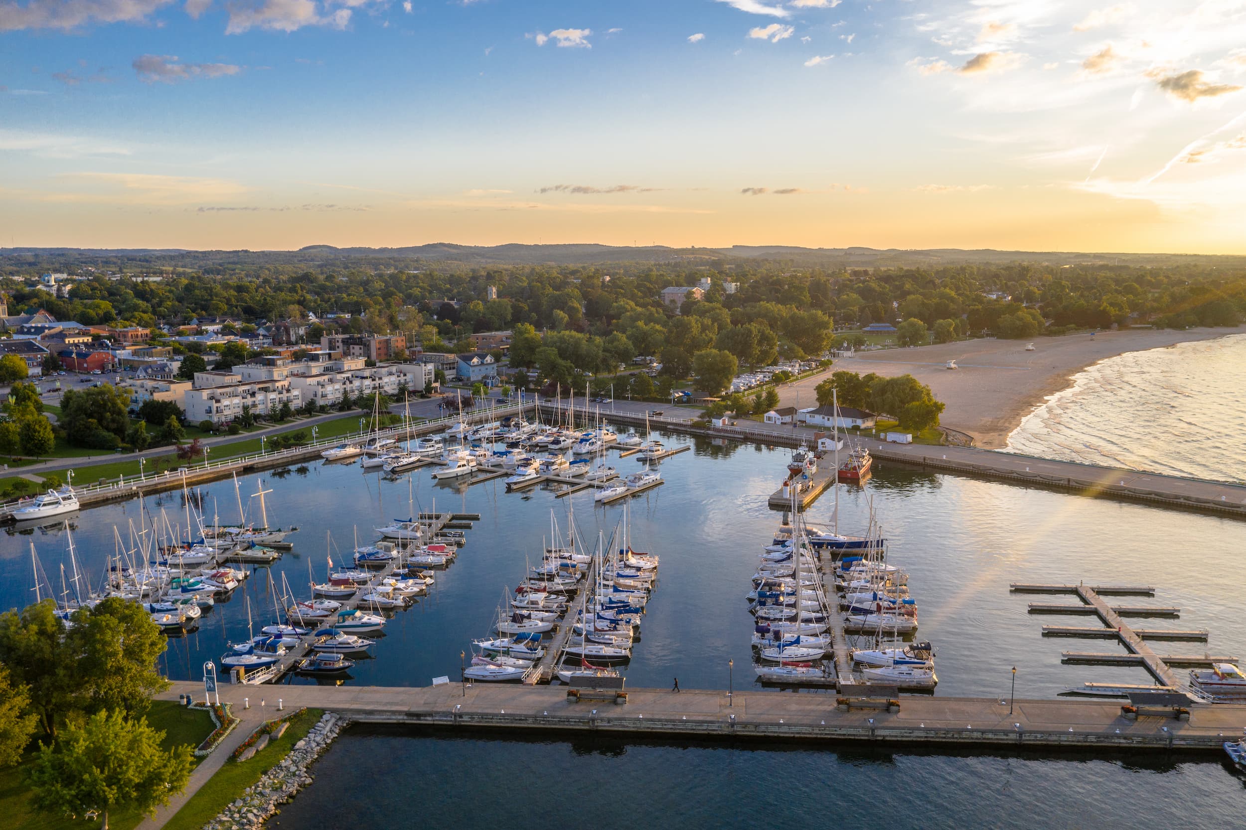 Drone view of Cobourg Marina with sail boats parked at slips