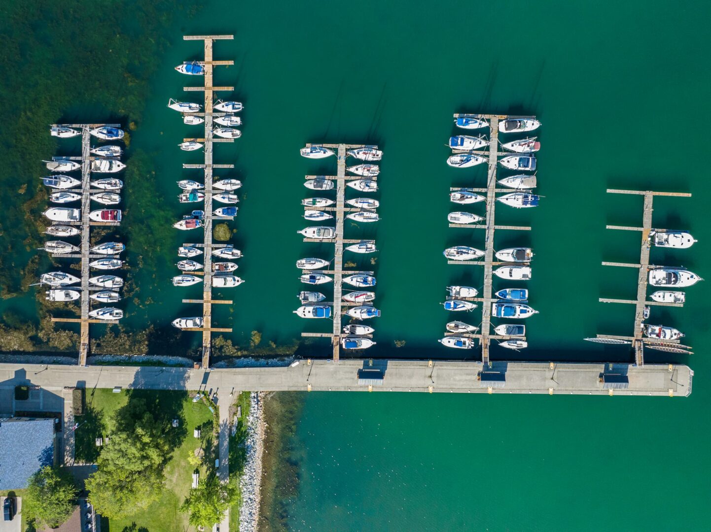 Top down view of boats parked at slips at Cobourg Marina.