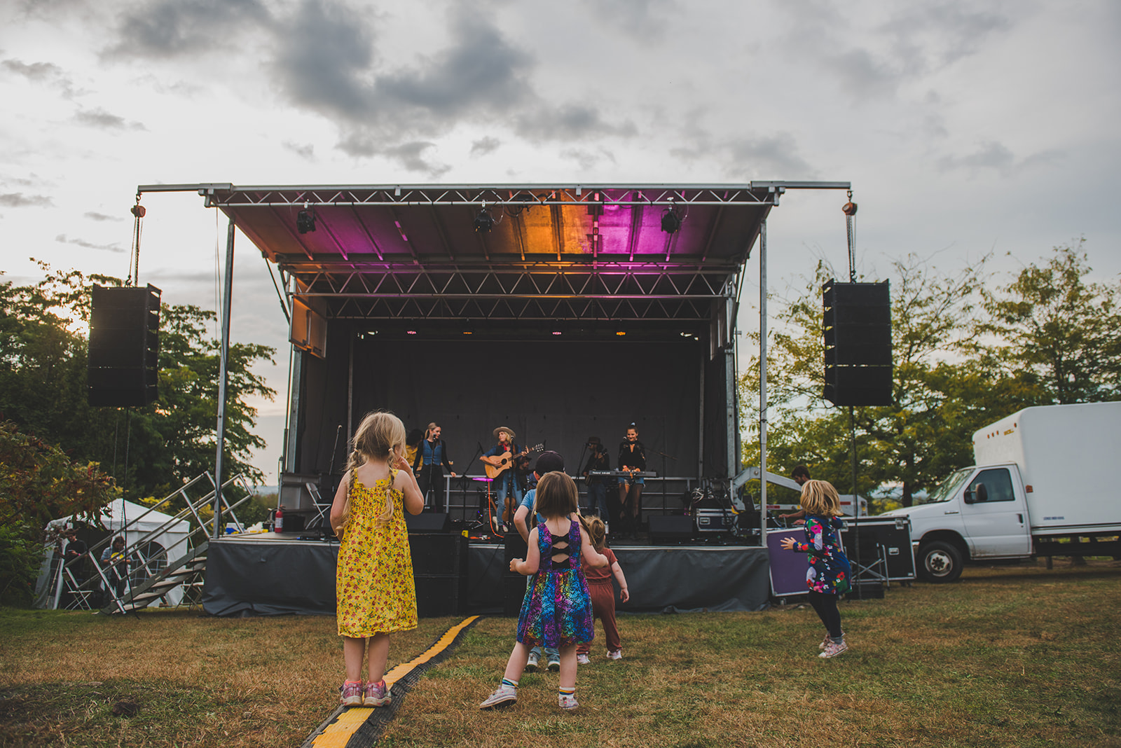 Children dancing at outdoor concert festival.