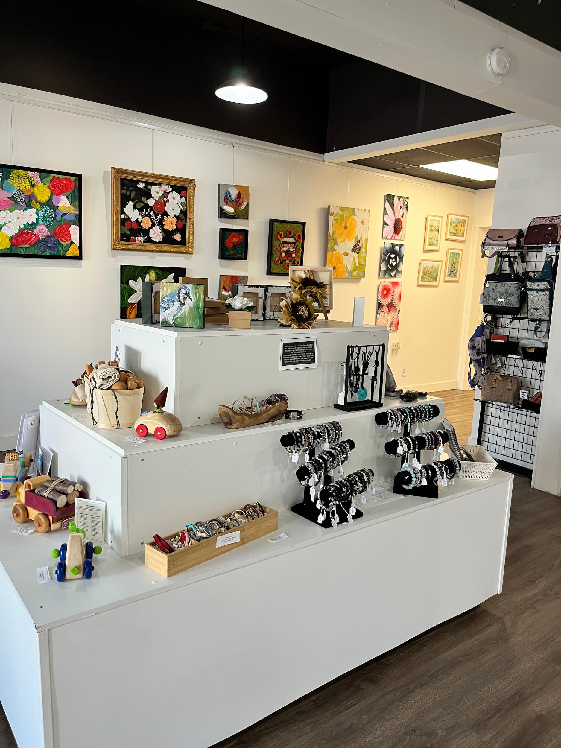 Interior of Presqu'ile Waddling Arts Centre featuring art on walls and on shelves.