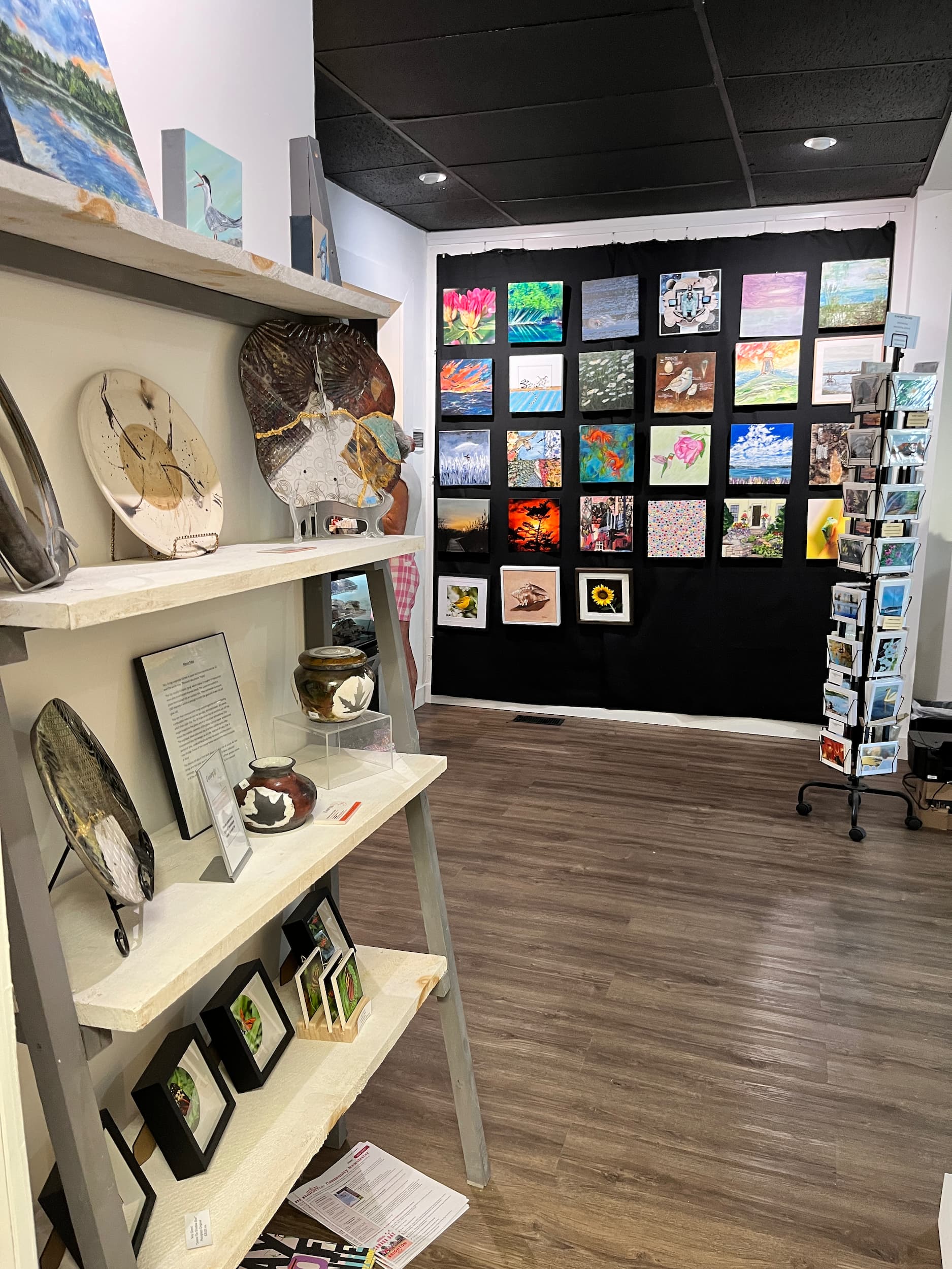 Interior of Presqu'ile Waddling Arts Centre featuring art on walls and on shelves.