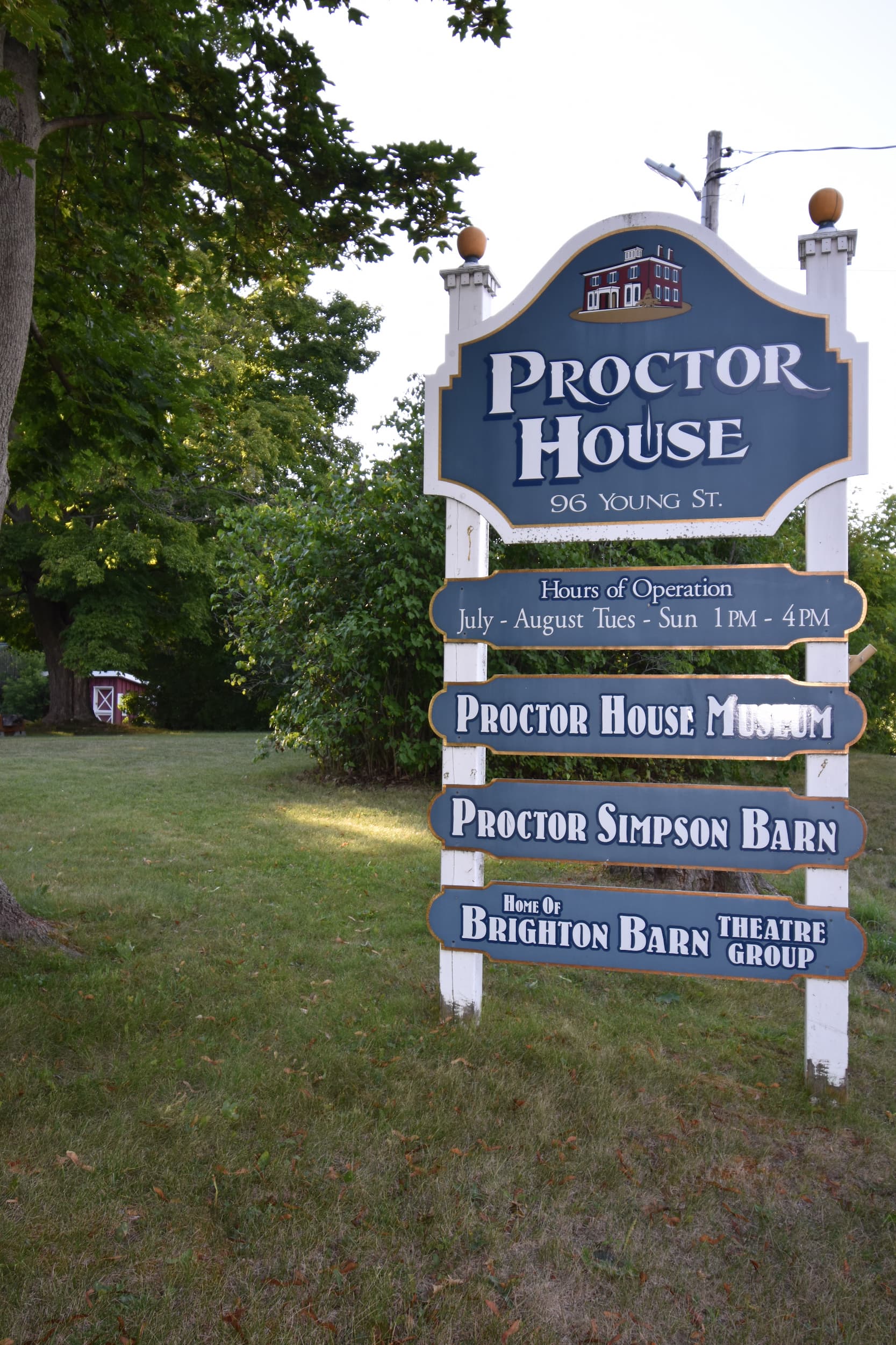 Sign for Proctor House listing different heritage venues at the location