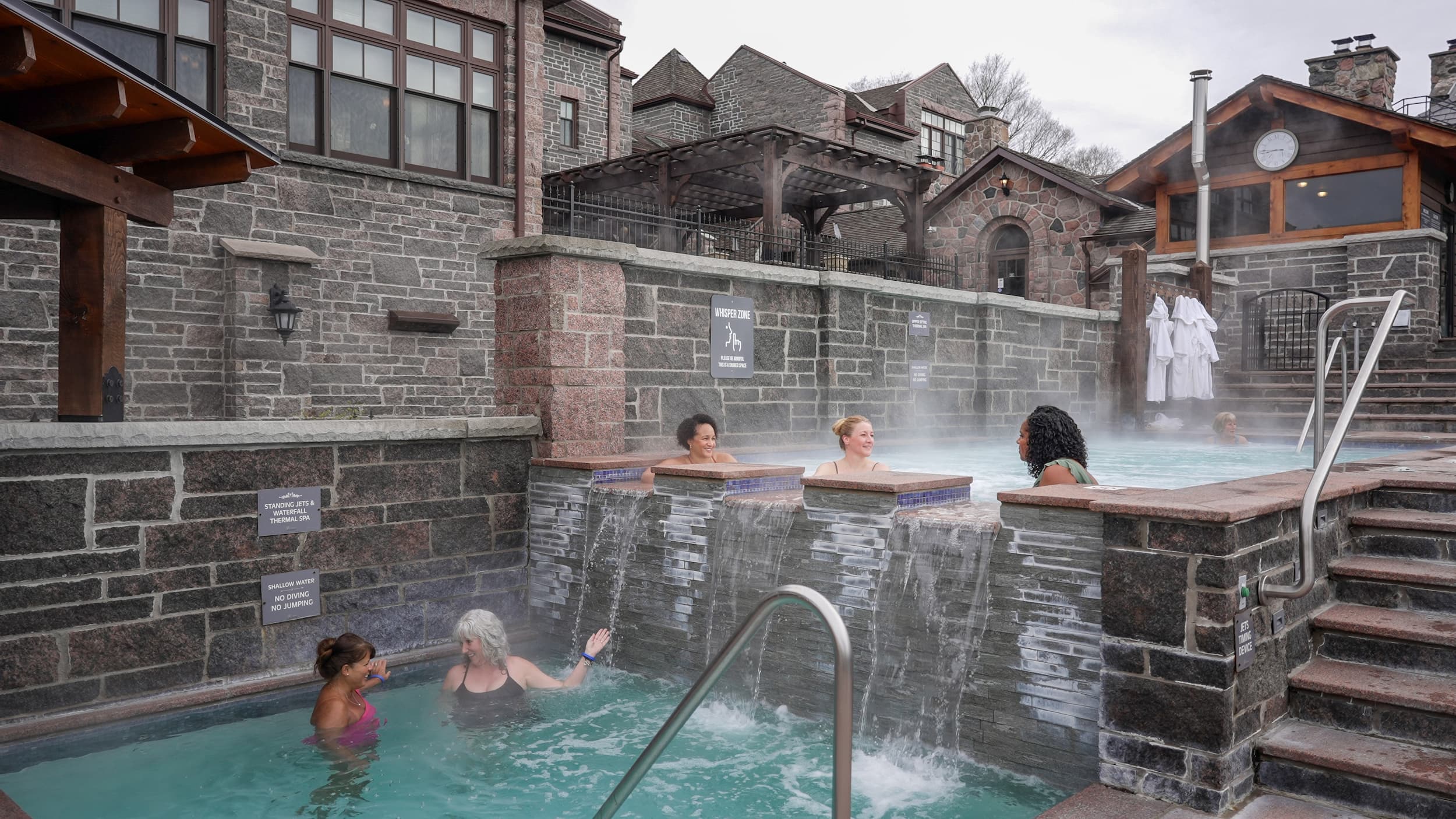 4 people in a multi-level hydrotherapy area