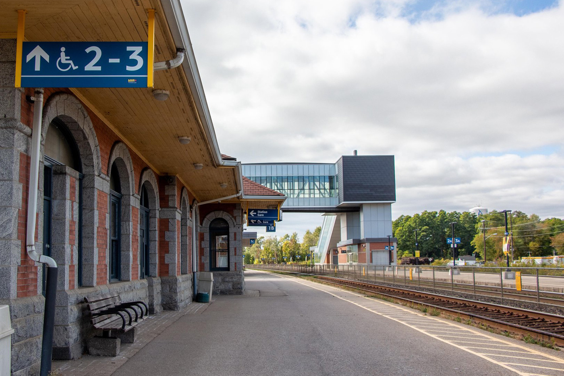 Exterior of VIA Rail Station in Cobourg featuring historic and modern buildings.