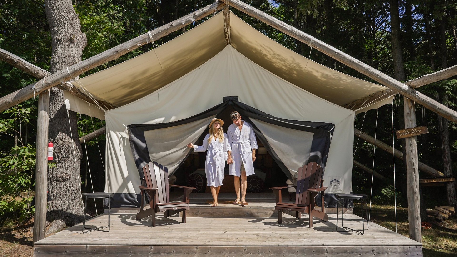 Couple coming out of a luxury glamping tent