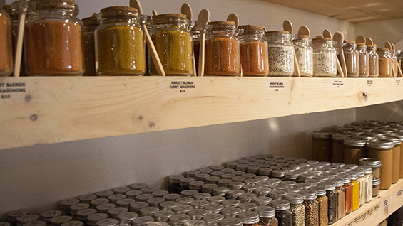 Jars of spices on a shelf.