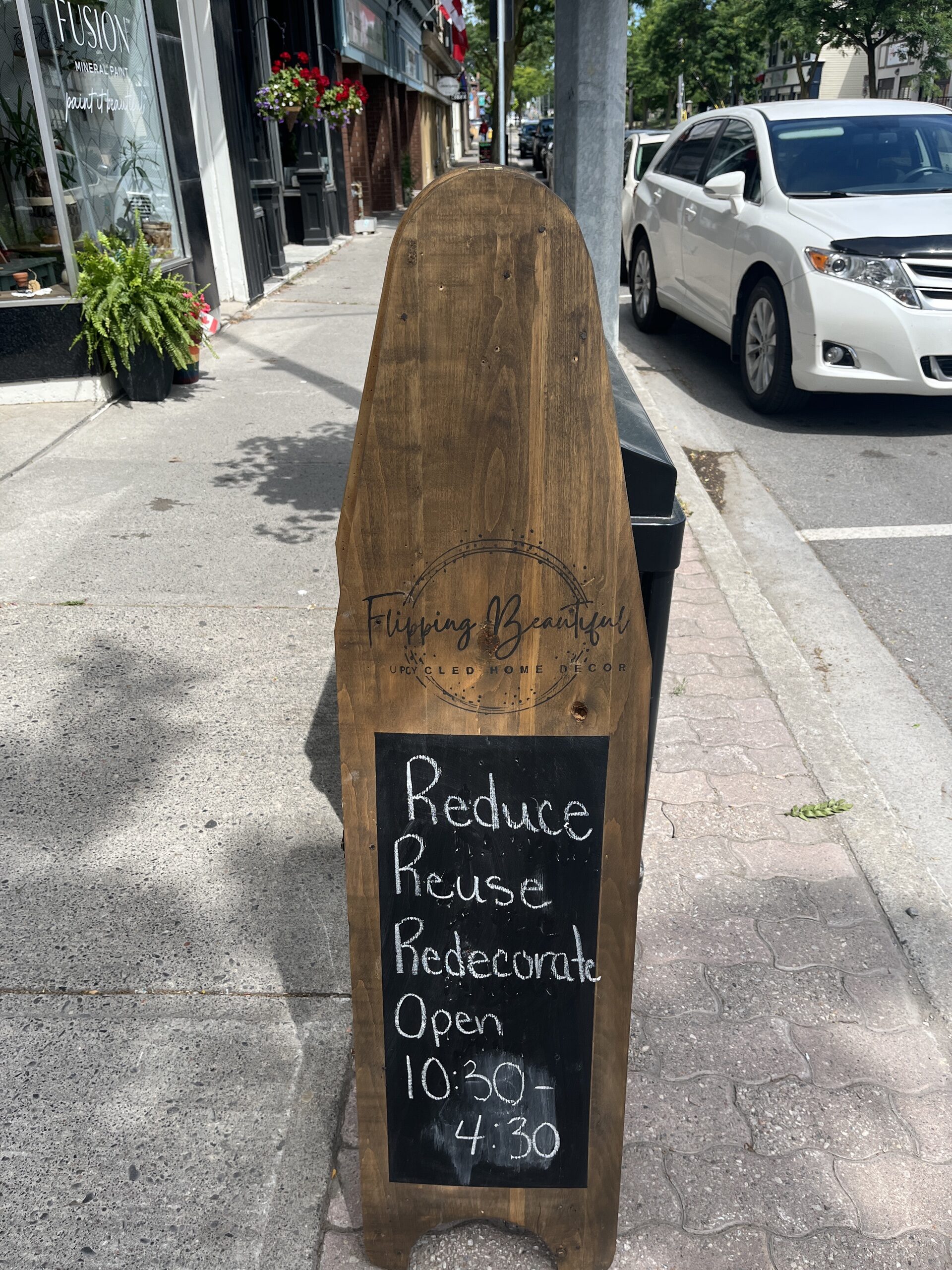 Flipping Beautiful Sign that reads "Reduce, Reuse, Redecorate. Open 10:30 to 4:30"