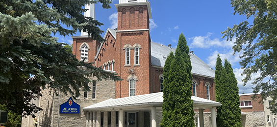 Large brick and stone building with large windows.