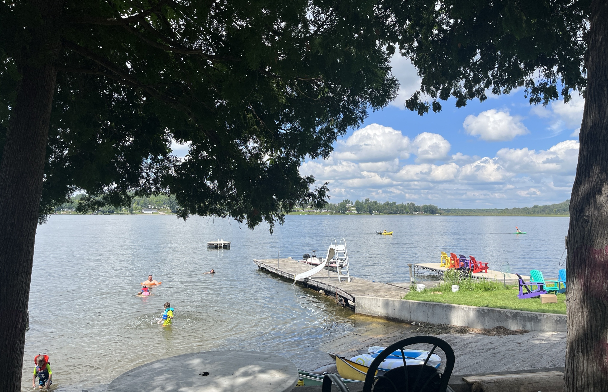 Photo of the lake with a dock and a slide going into the water,