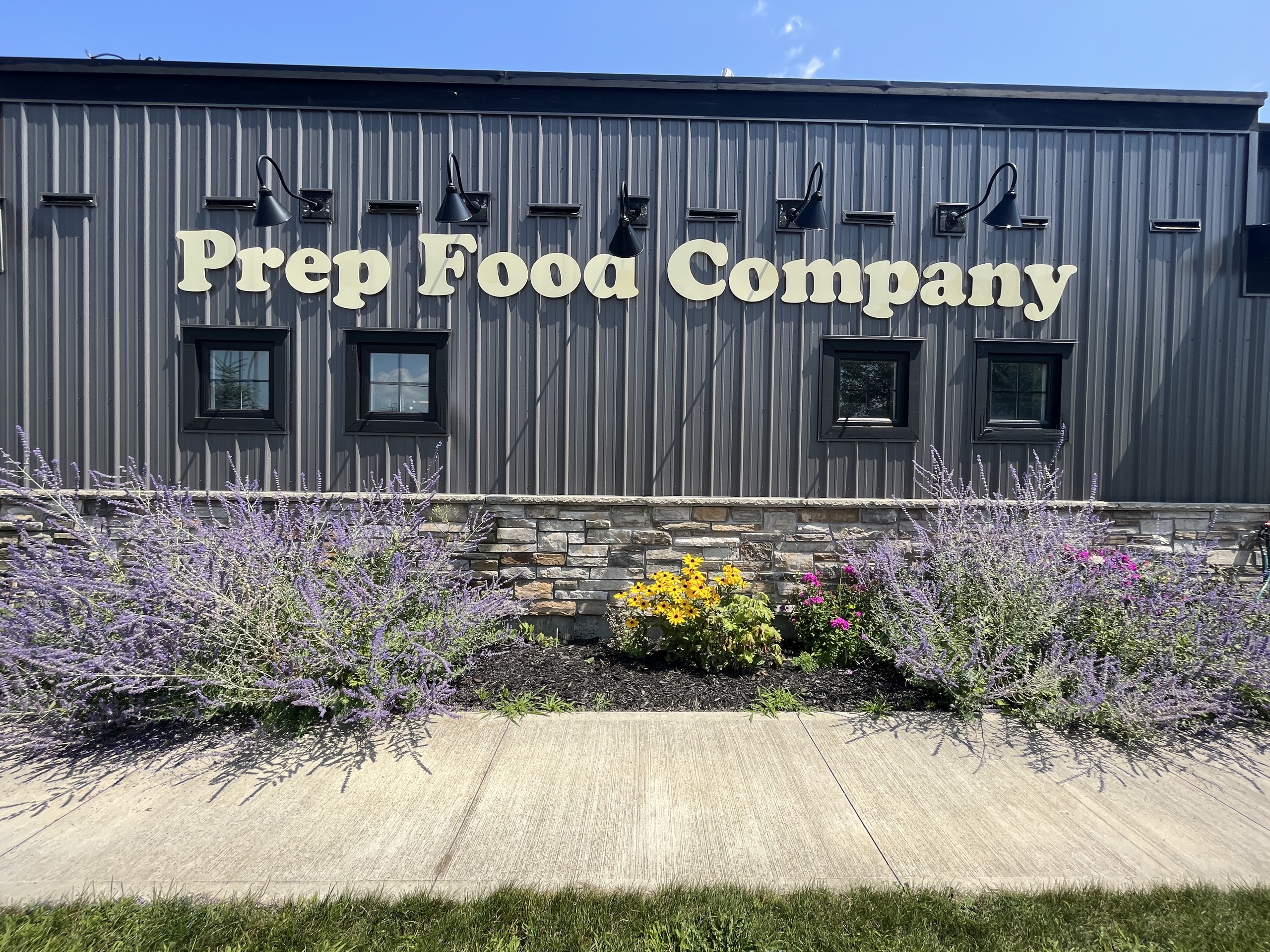 Photo of the outside of Prep Food Co. The sign on the side of the building reads "Prep Food Company."