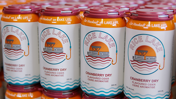 White cans with orange, cranberry and blue finishings on display.