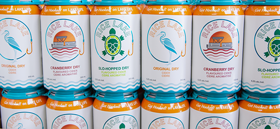 White cans with orange and blue finishings on display.