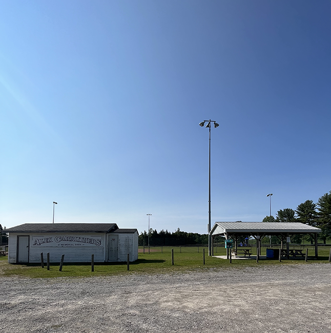 Recreation park with shelters, ball diamonds, play structure.
