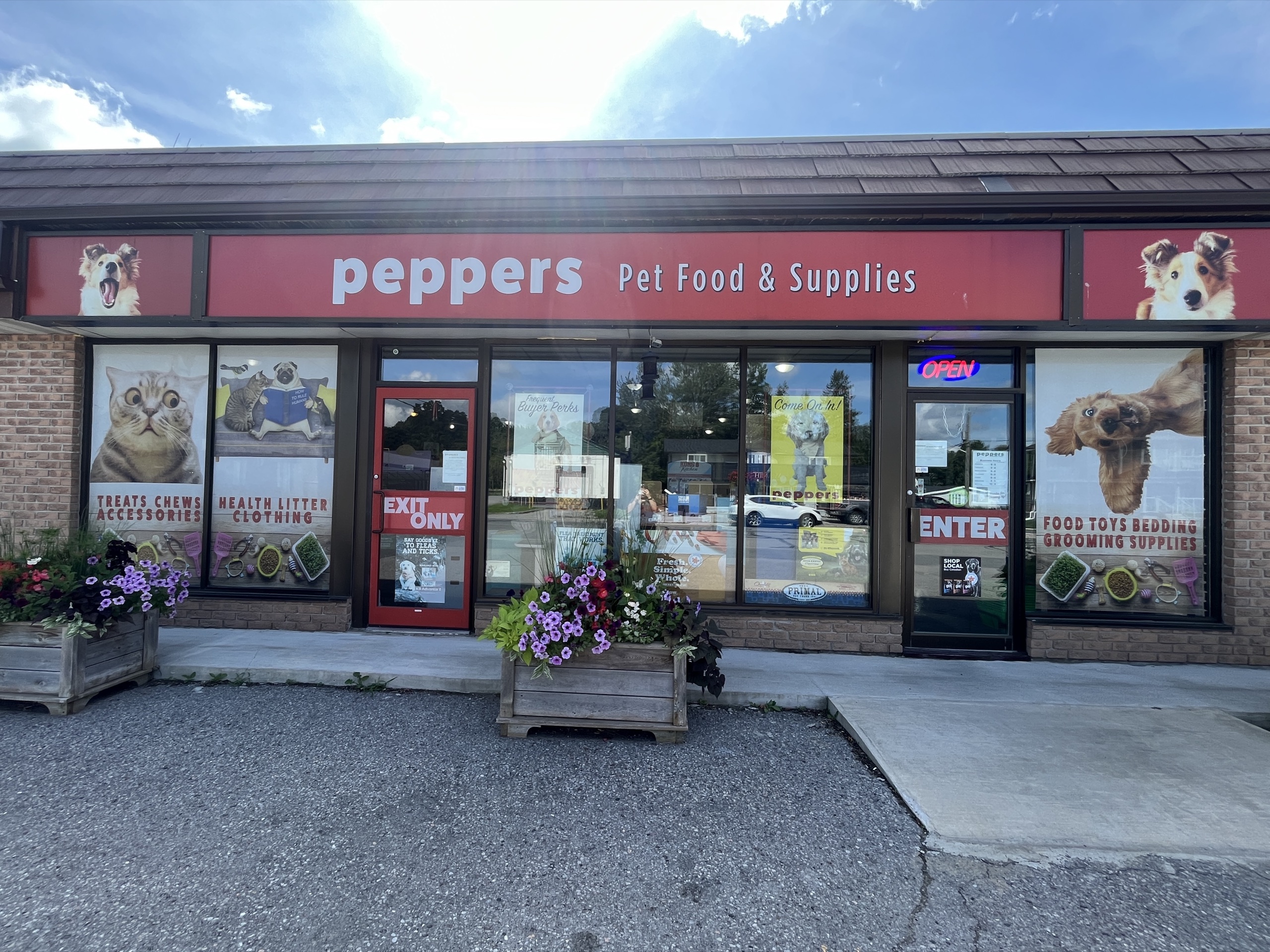 Photo outside of Peppers Pet Food & Supplies. Sign above the front doors read "Peppers Pet Food & Supplies."