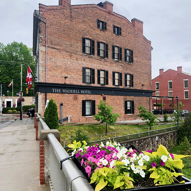 Large brick building with black trim and white letters.