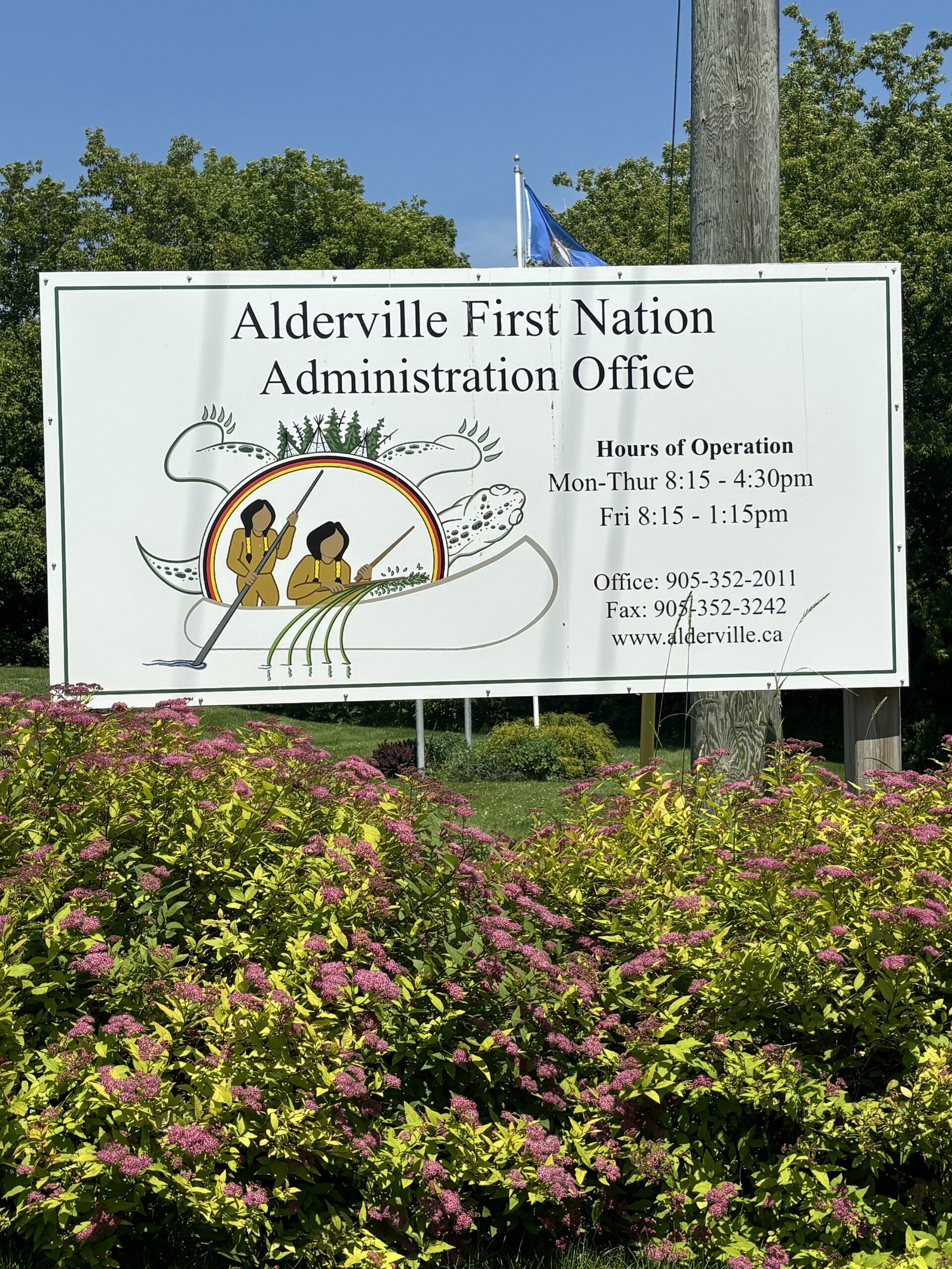 Photo of Alderville First Nation Administration Office sign. Sign reads "Alderville First Nation Administration Office. Hours of Operation. Mon-Thurs 8:15-4:30. Fri 8:15-1:15. Office: 9053522011. www.alderville.ca"