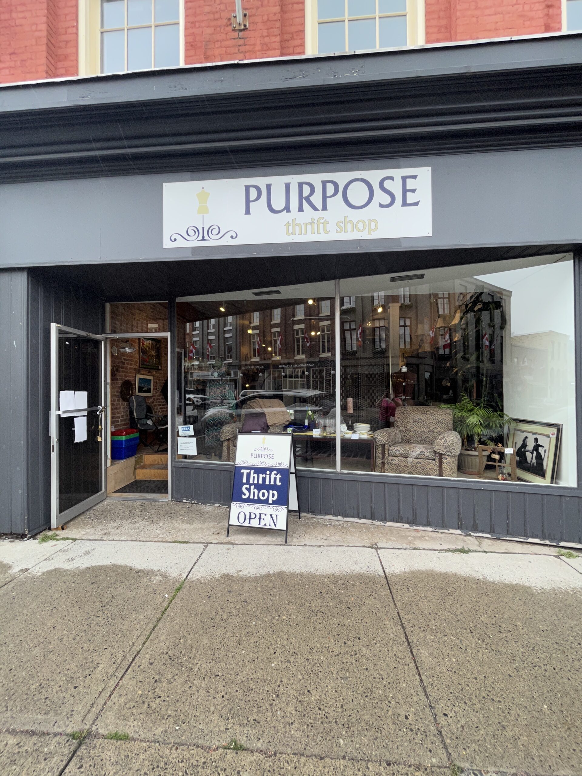 Photo of Purpose Thrift Store store front. Sign above entrance reads "Purpose thrift store open."