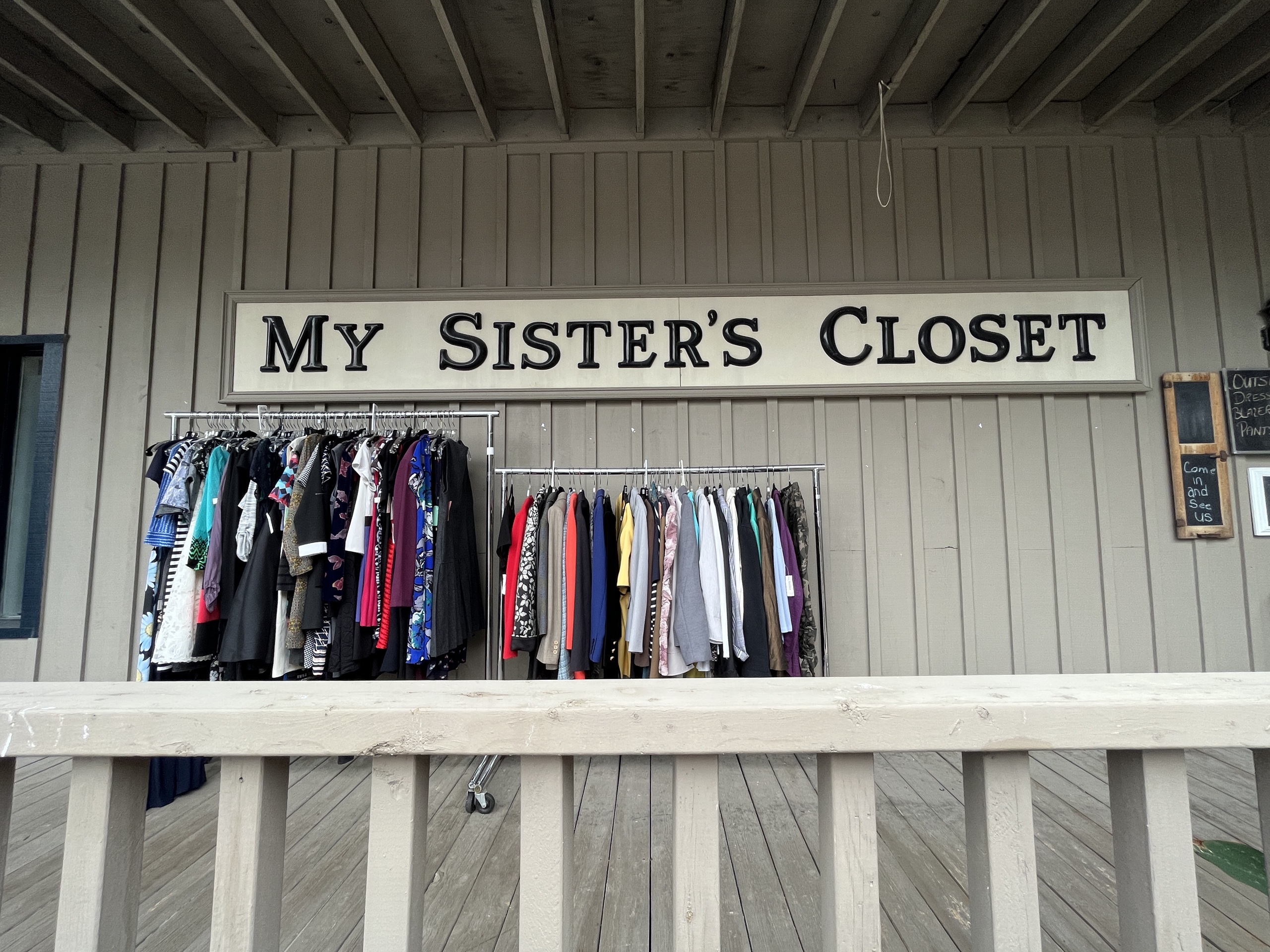 Photo of My Sister's Closet store front. Sign above clothing rack reads "My Sister's Closet."