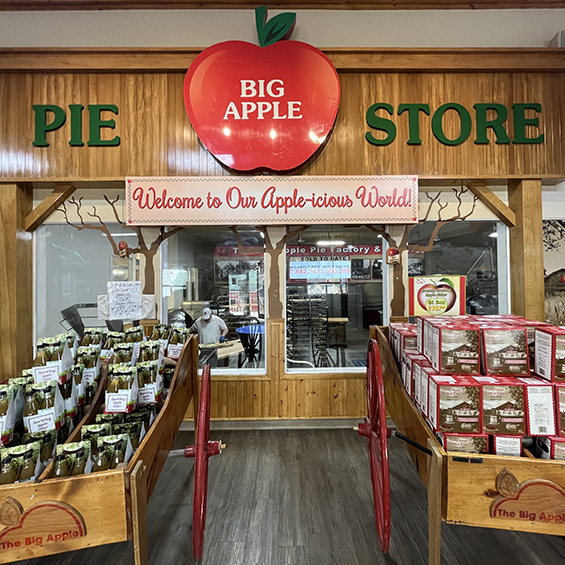 Items on display with a window view into the pie factory at The Big Apple.