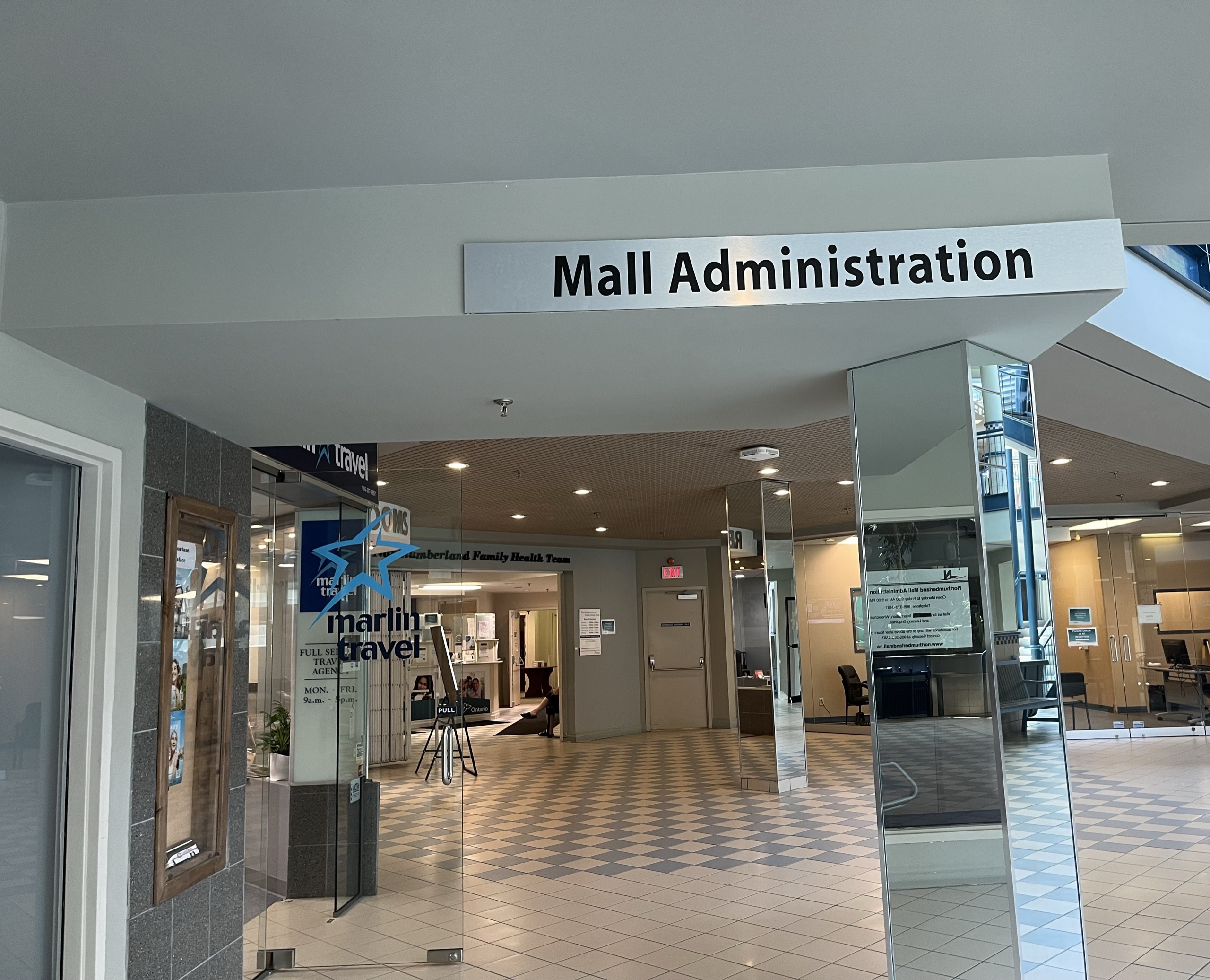 Photo of inside of Northumberland Mall. Sign at the top of the hallway reading "Mall Administration."