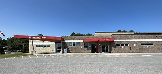 Wide brick building with red overhead signs.