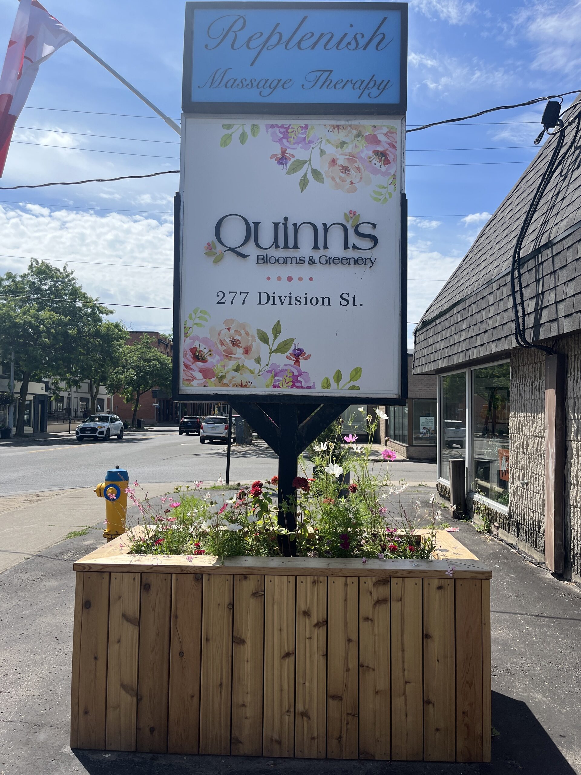 Photo of Quinns Blooms sign. Sign reads "Quinns Blooms & Greenery. 277 Division St."