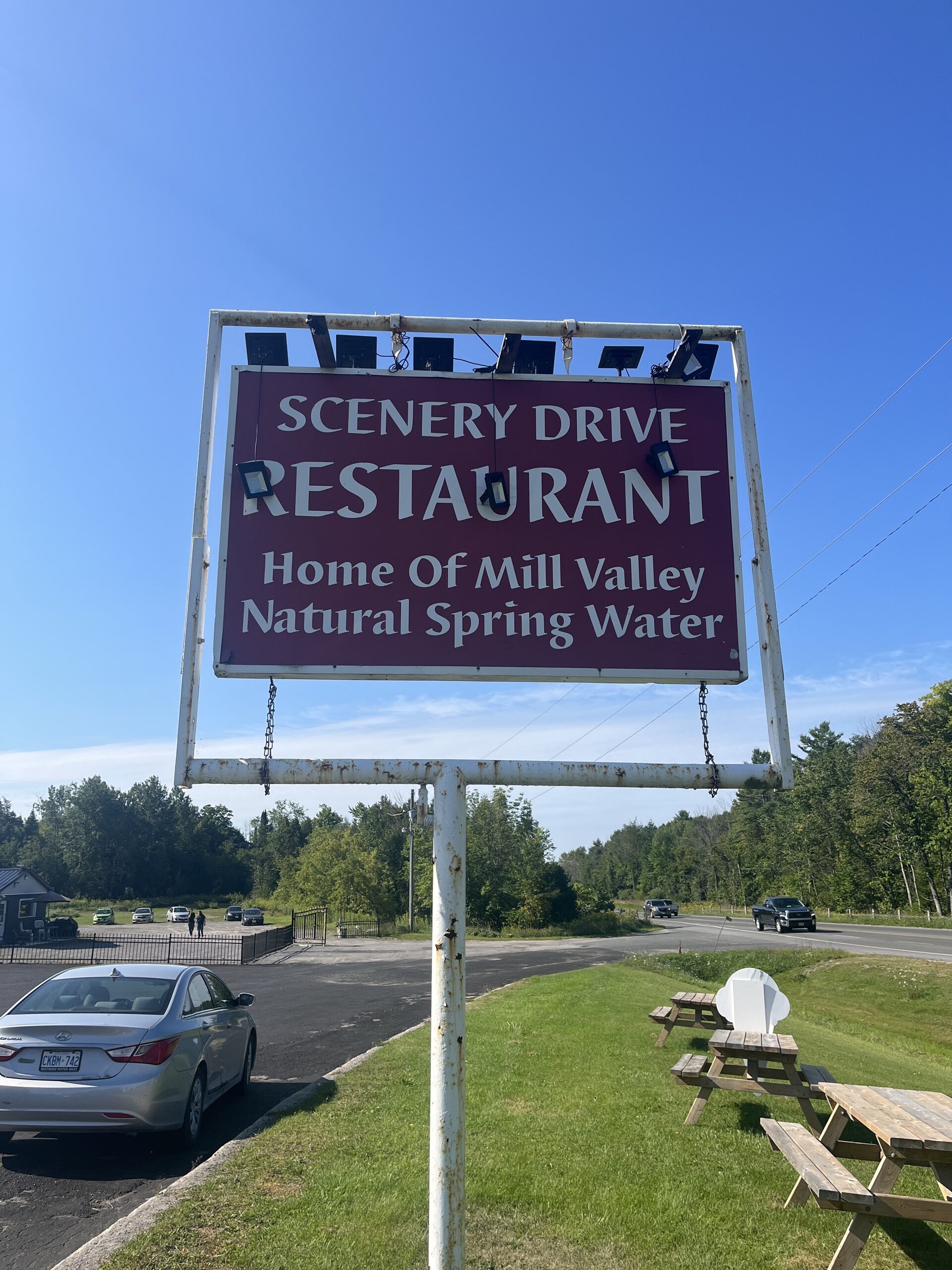 Photo of Scenery Drive Restaurant sign. Sign reads "Scenery drive restaurant. Home of mill valley natural spring water."