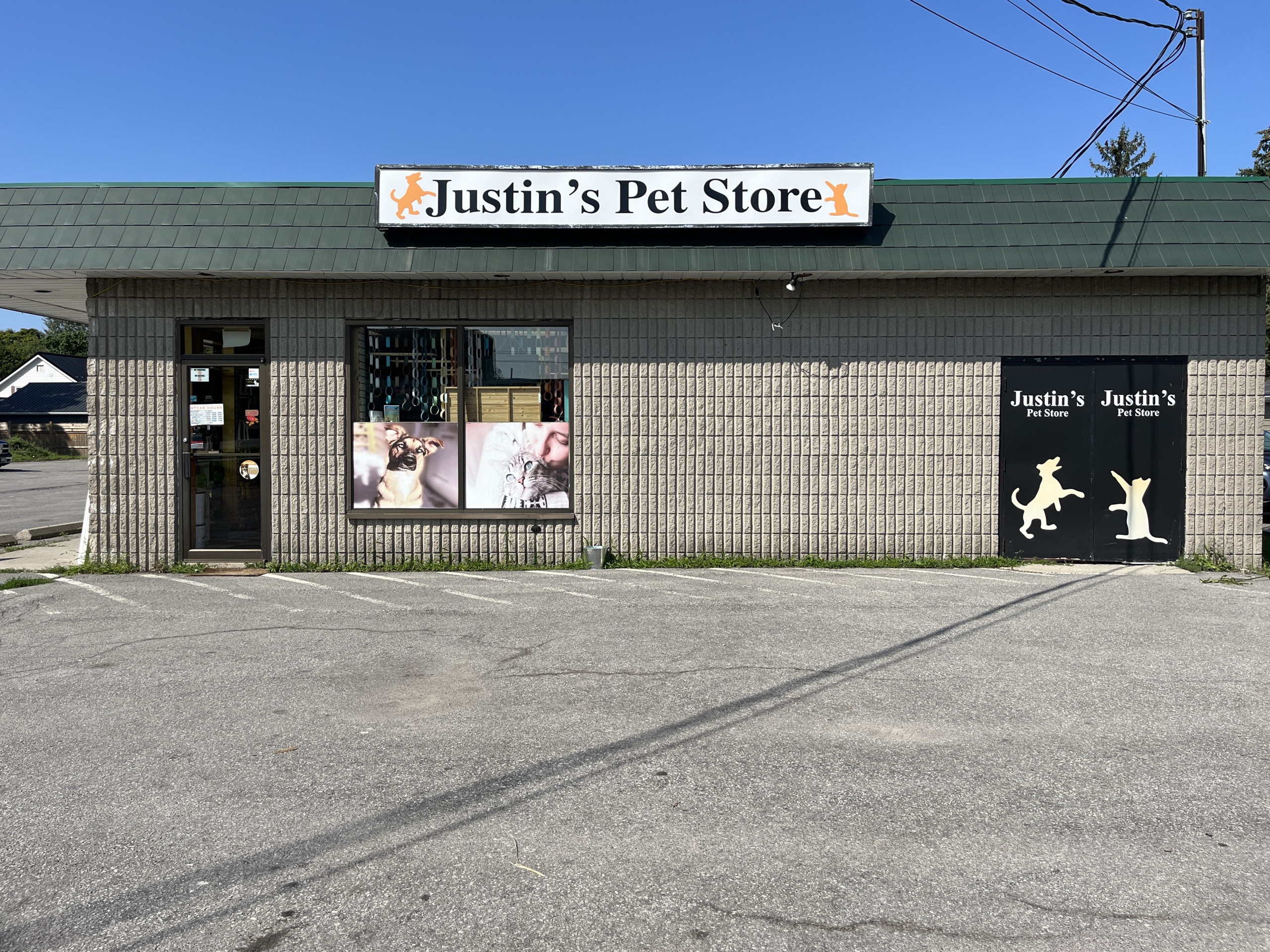Photo of Justin's Pet Store storefront. Photo shows a sign above the window reading "Justin's Pet Store."