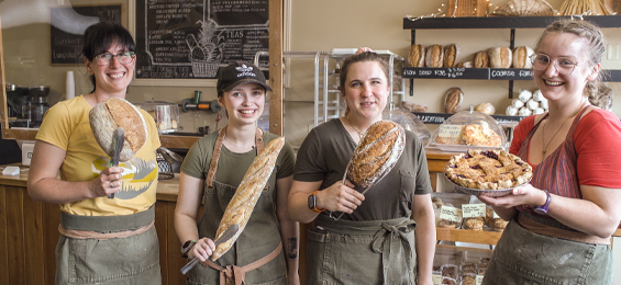 Photo of four female staff members holding MillStone Bread.