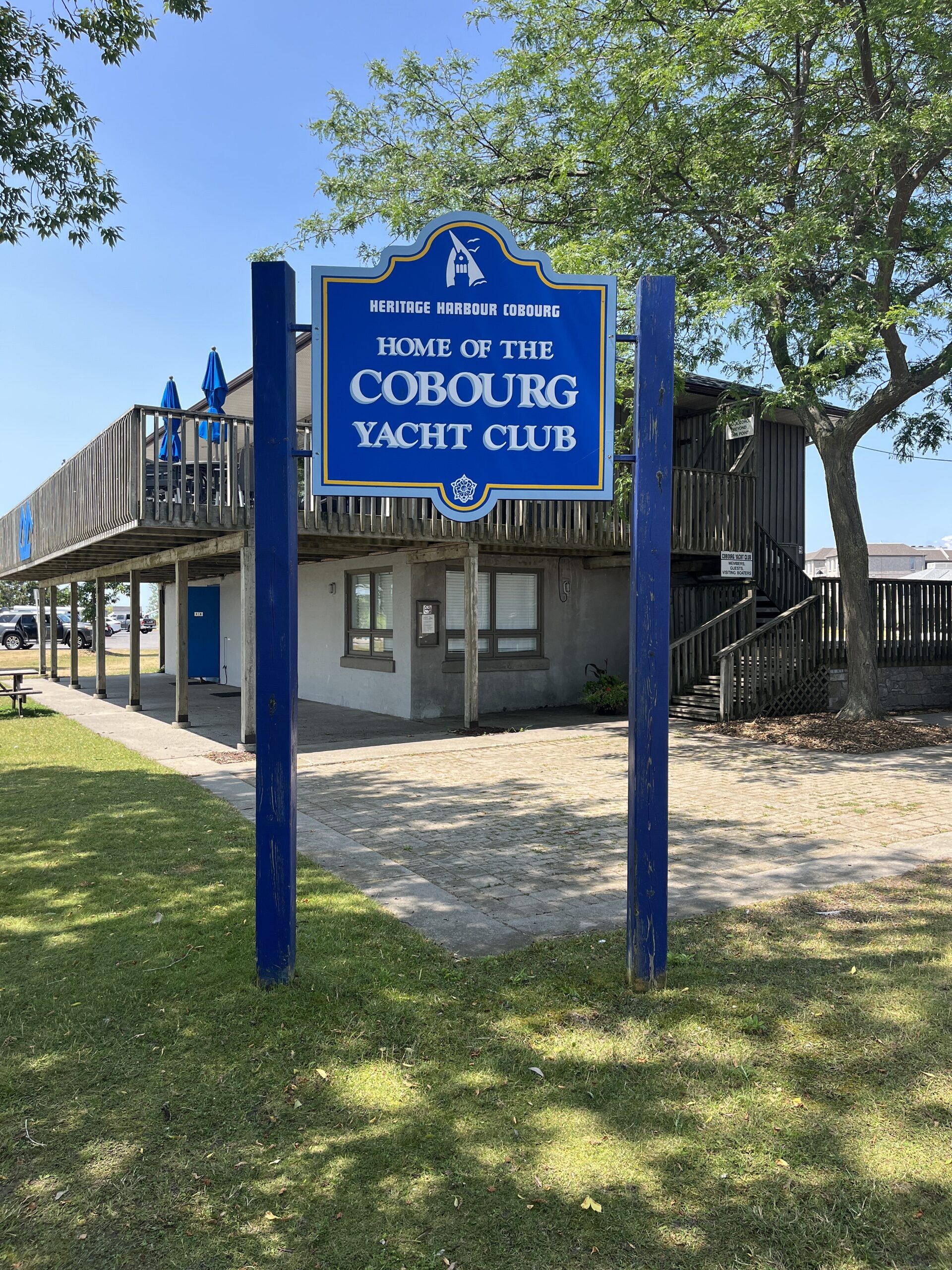 Photo of Cobourg Yacht Club sign. Sign reads "Heritage Harbour Cobourg. Home of the Cobourg Yacht Club."