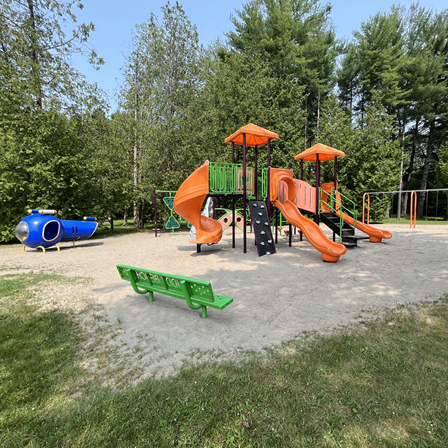 Orange and green play structure with 3 slides.
