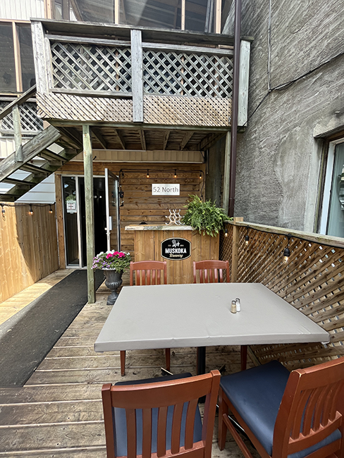 Grey tables and chairs on a patio.