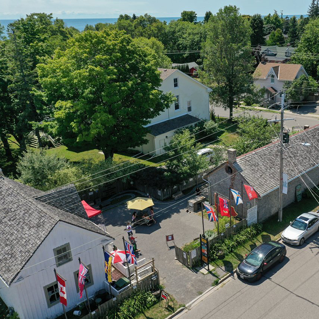 Overhead view of 2 buildings with sitting area between.