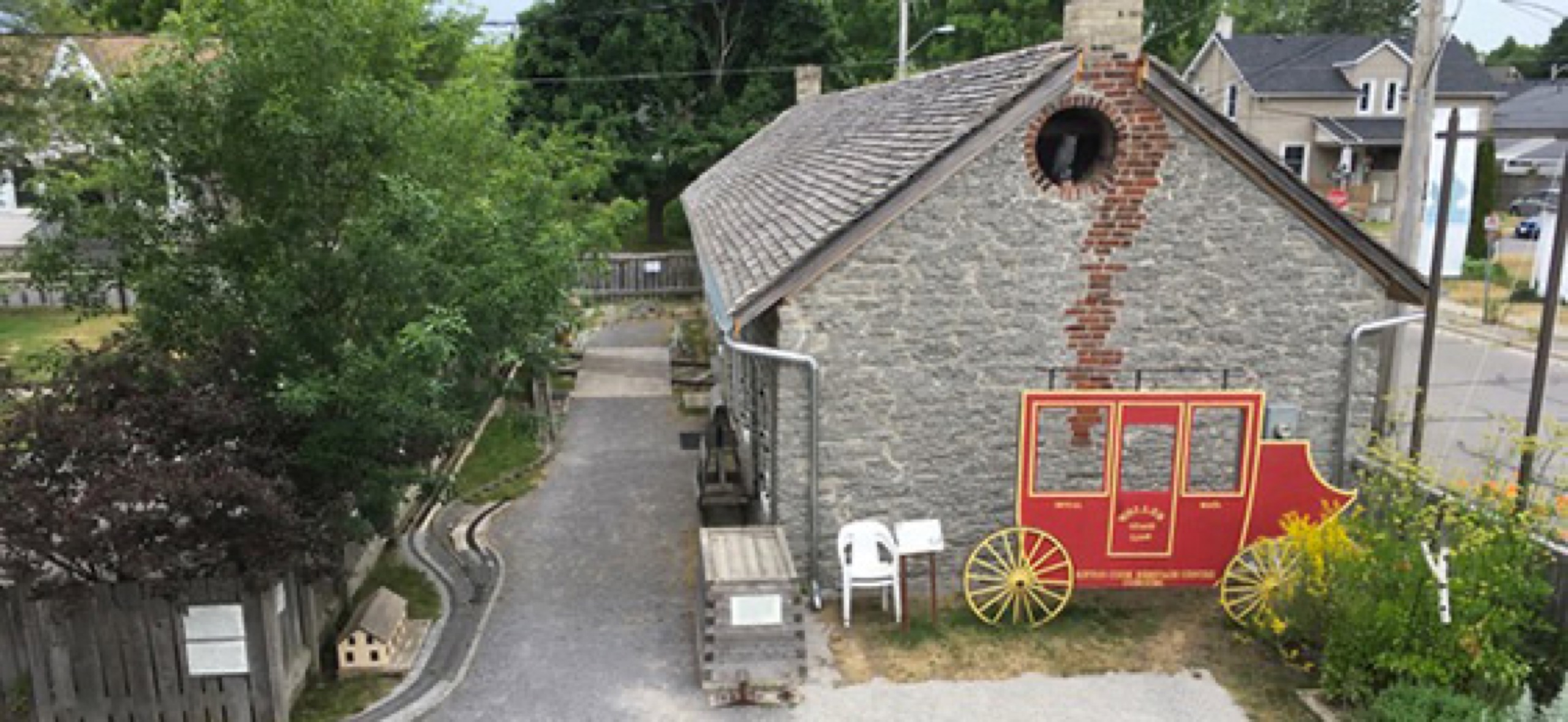 Stone building with a graphic of a red train cart on the side.