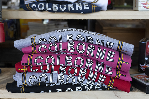 Stack of different coloured t-shirts with Colborne on front.