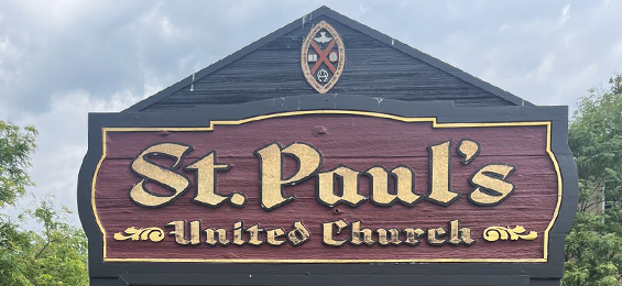 Burgundy sign with yellow writing.