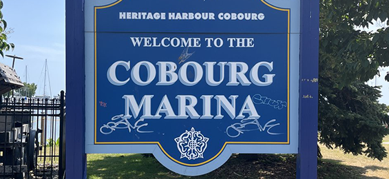 Blue city sign with white writing.