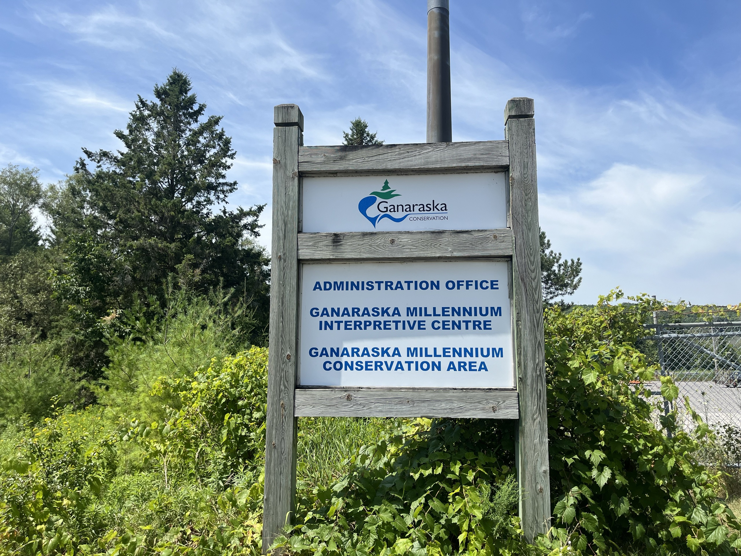 Photo of Ganaraska Conversation sign. Sign reads "Administration office. Ganaraska millenium interpretive centre. Ganaraska millennium conservation area."