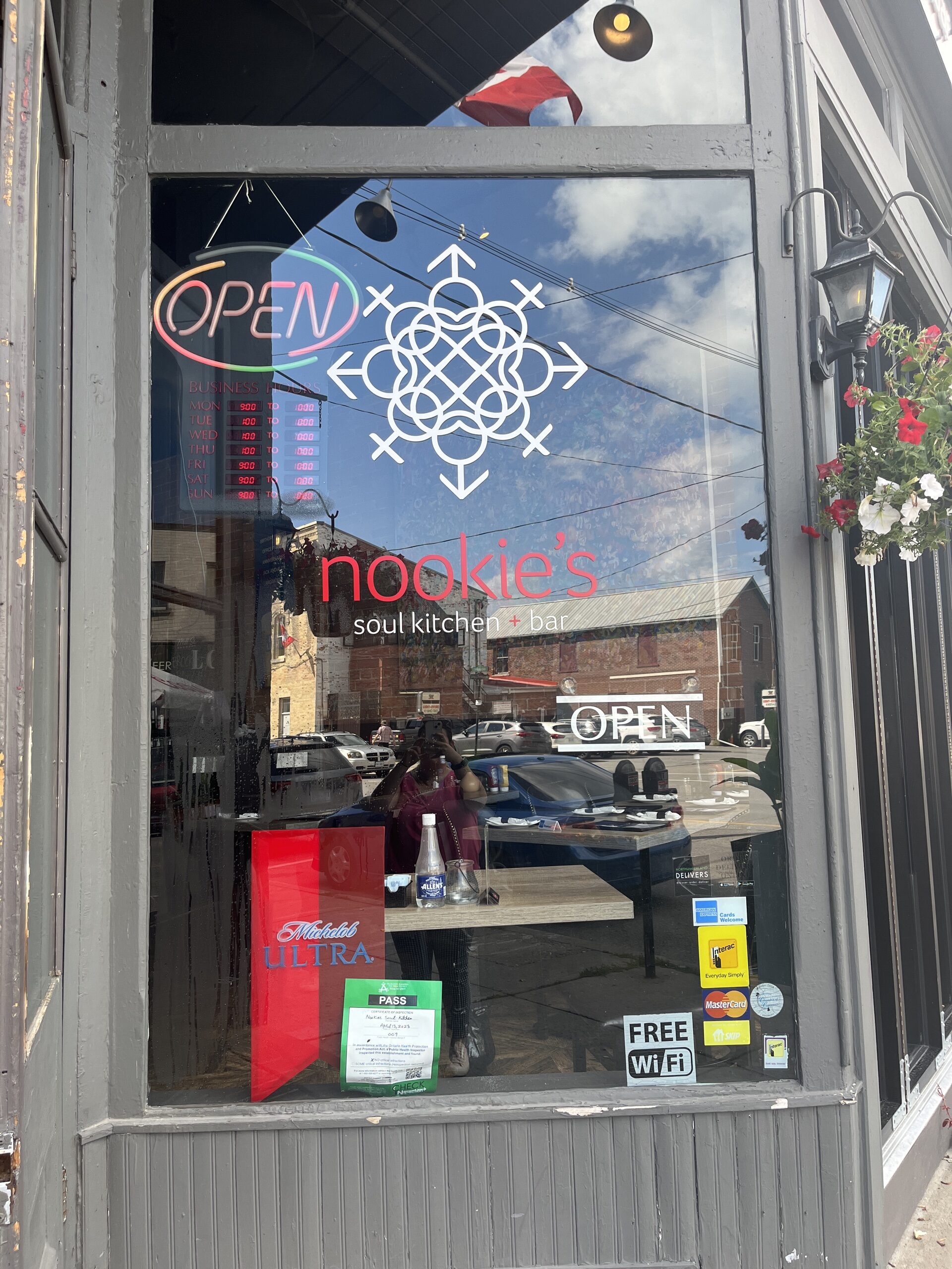 Photo of Nookie's Soul Kitchen & Bar window. Window has Nookie's Soul Kitchen & Bar written on it with an open sign in the top left corner.